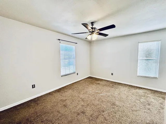 an empty room with a empty space and windows