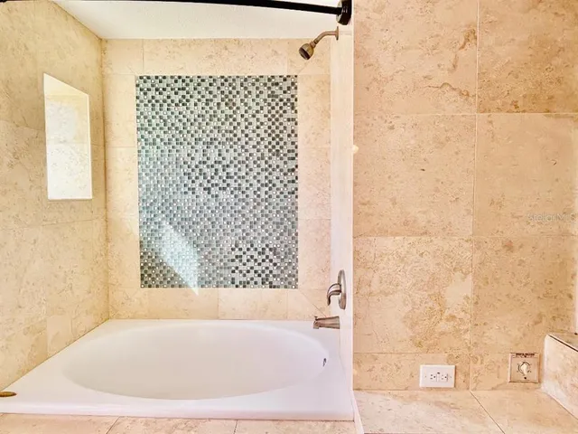 a bathroom with a bathtub and shower