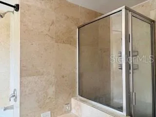 a bathroom with a glass shower door