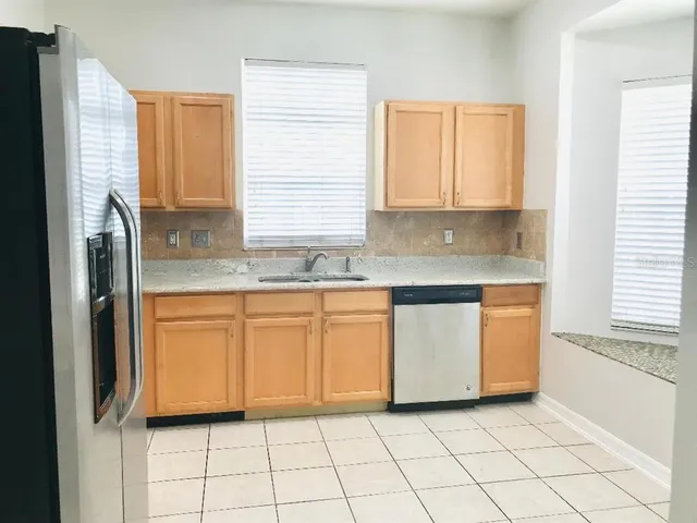 a kitchen with stainless steel appliances granite countertop a sink and a granite counter tops