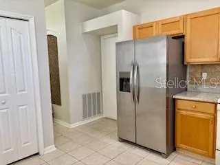 a kitchen with stainless steel appliances granite countertop a refrigerator and a stove