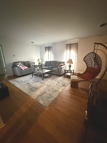 a room with a couch and a refrigerator