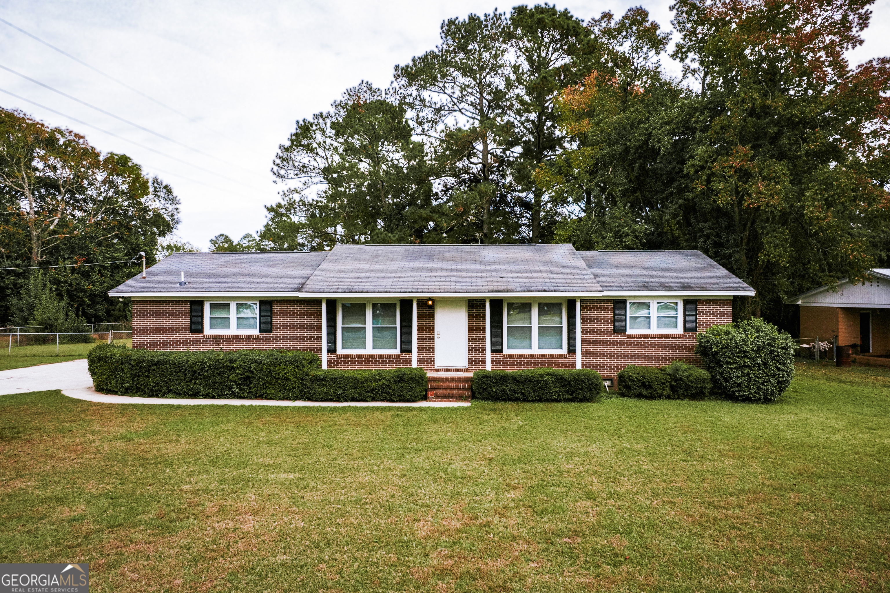 a front view of a house with garden