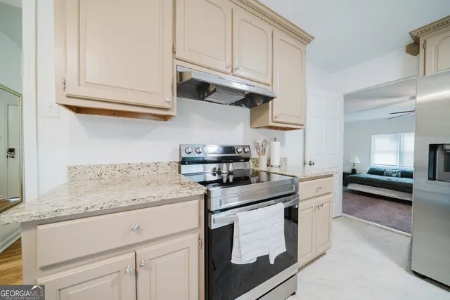 a kitchen with stainless steel appliances granite countertop a sink stove and cabinets