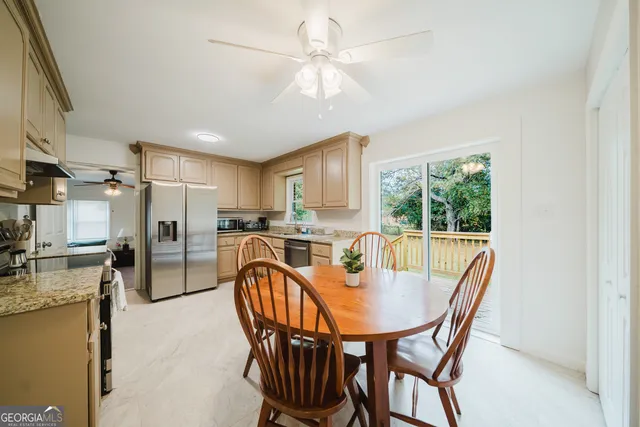 a dining room with furniture and a kitchen view