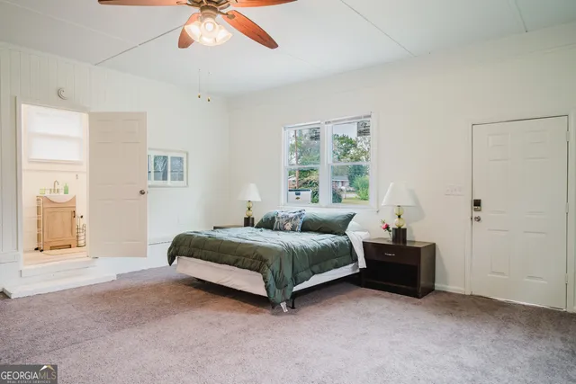 a spacious bedroom with a bed and a chandelier
