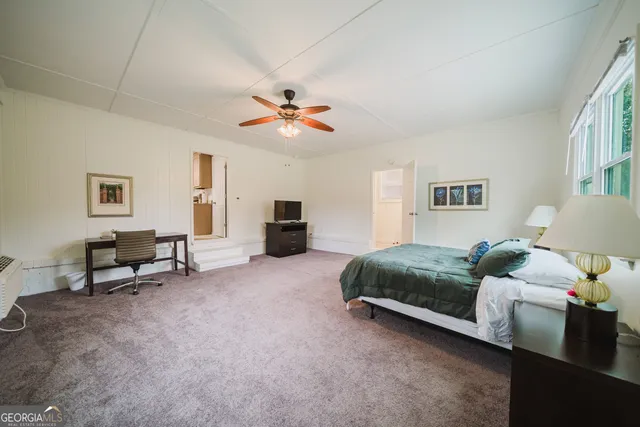 a spacious bedroom with a bed and a chandelier