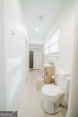 a white toilet sitting next to a bathroom sink