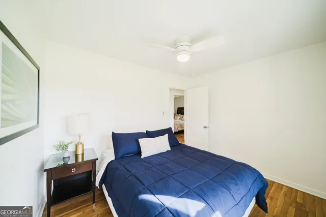 a bedroom with a bed and a mirror