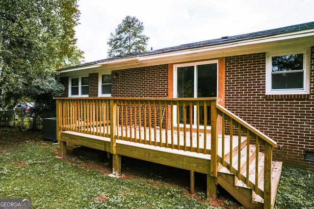 a view of a house with a yard and a deck