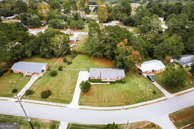 an aerial view of residential houses with outdoor space