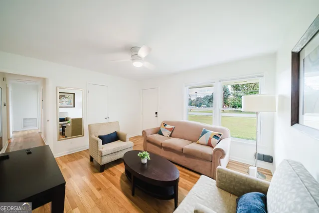a living room with furniture and a large window