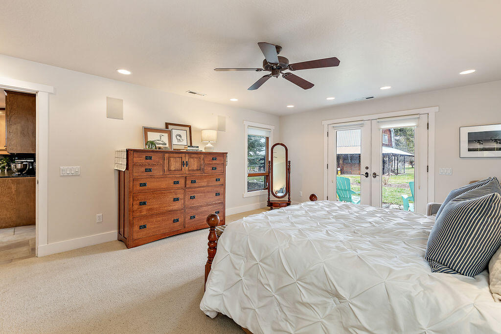 3828 Upper Applegate Road Jacksonville, OR 97530 - Photo 36 of 69 a bedroom with a bed a dresser and a window