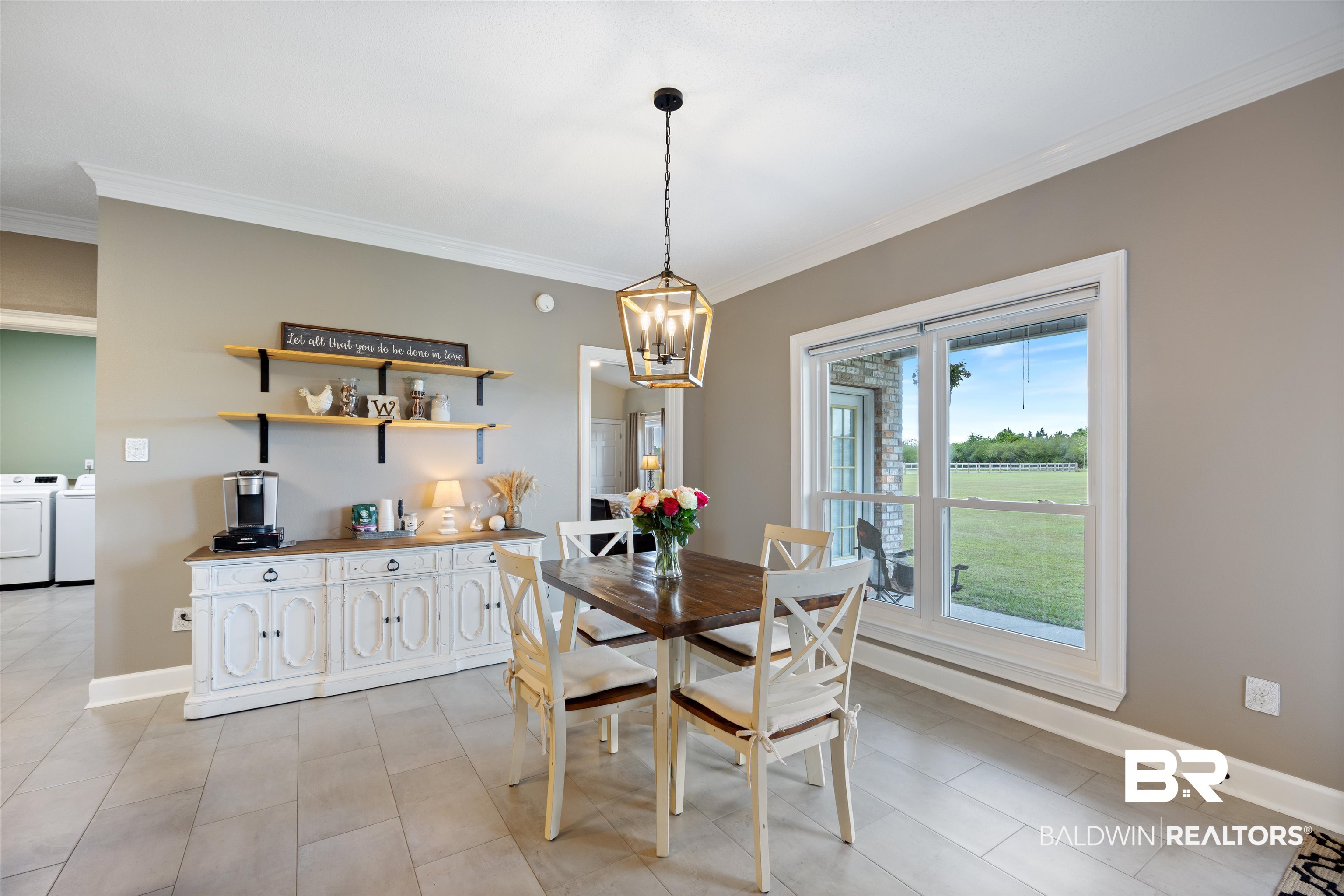 9855 Stucki Road Elberta, AL 36530 - Photo 19 of 54 Dining room with ornamental molding, washer and clothes dryer, and a chandelier