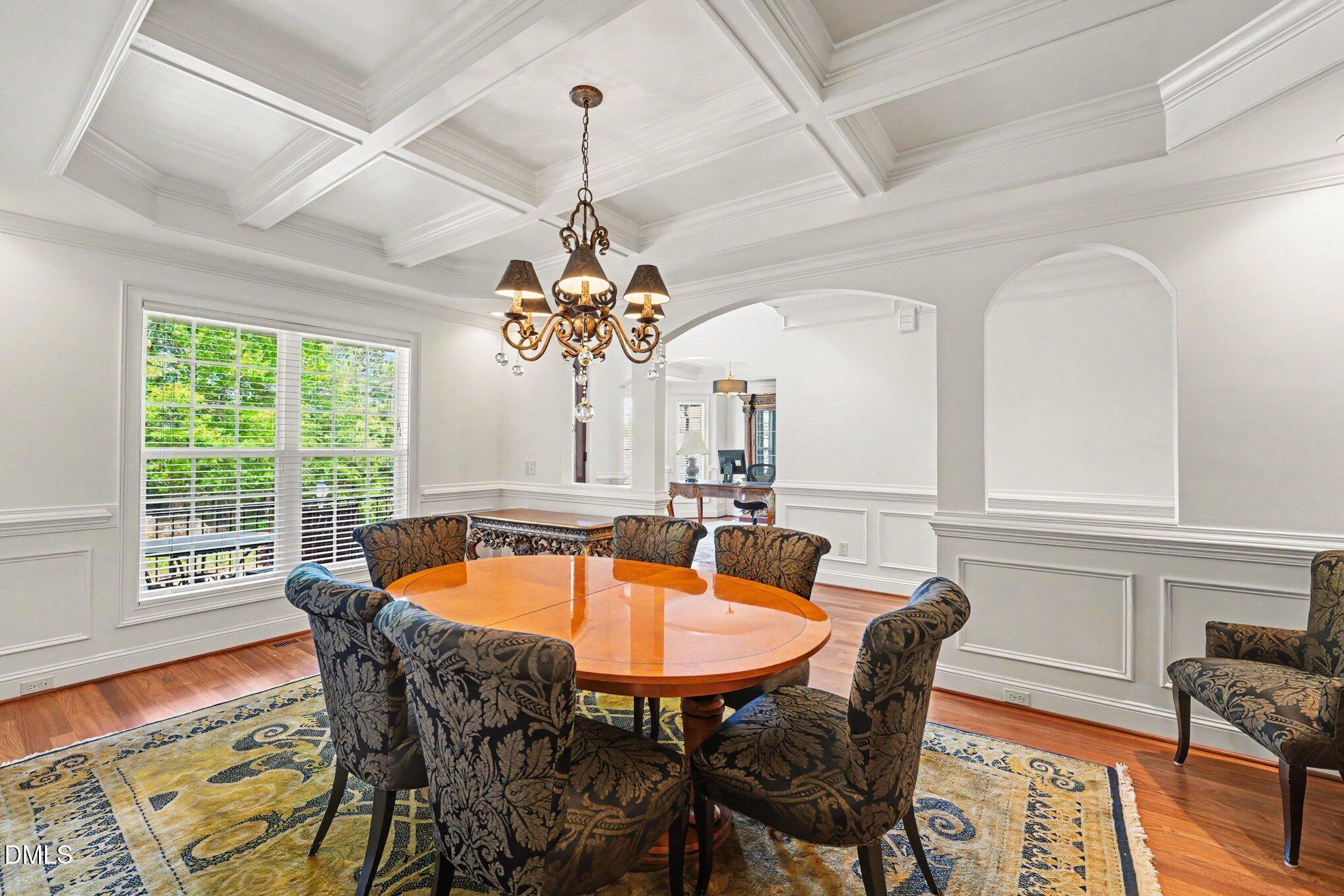 1729 Frenchwood Drive Raleigh, NC 27612 - Photo 4 of 46 a dining room with furniture a chandelier and wooden floor
