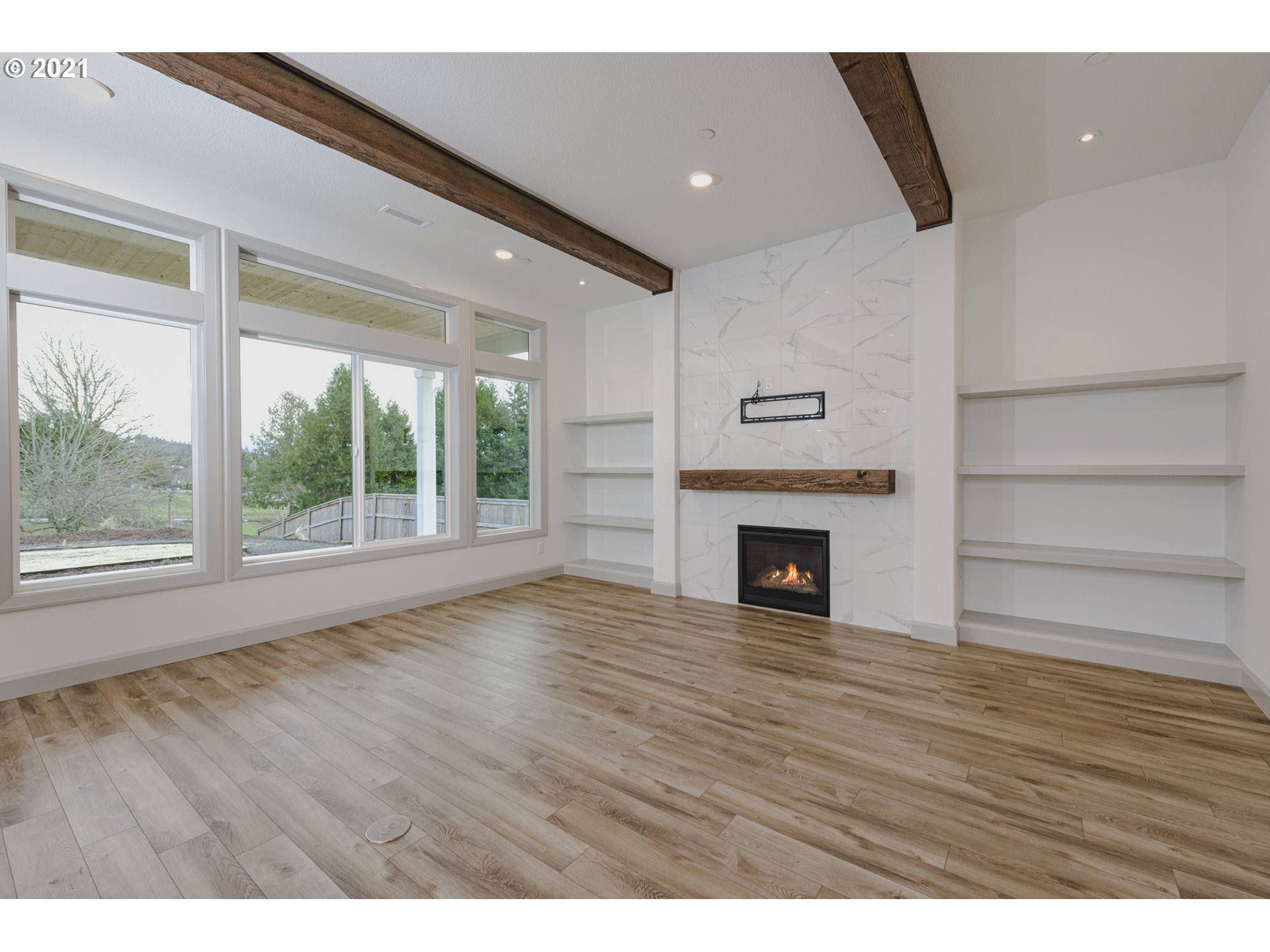 2325 South Royal Court Ridgefield, WA 98642 - Photo 14 of 30 a view of an empty room with wooden floor fireplace and a window