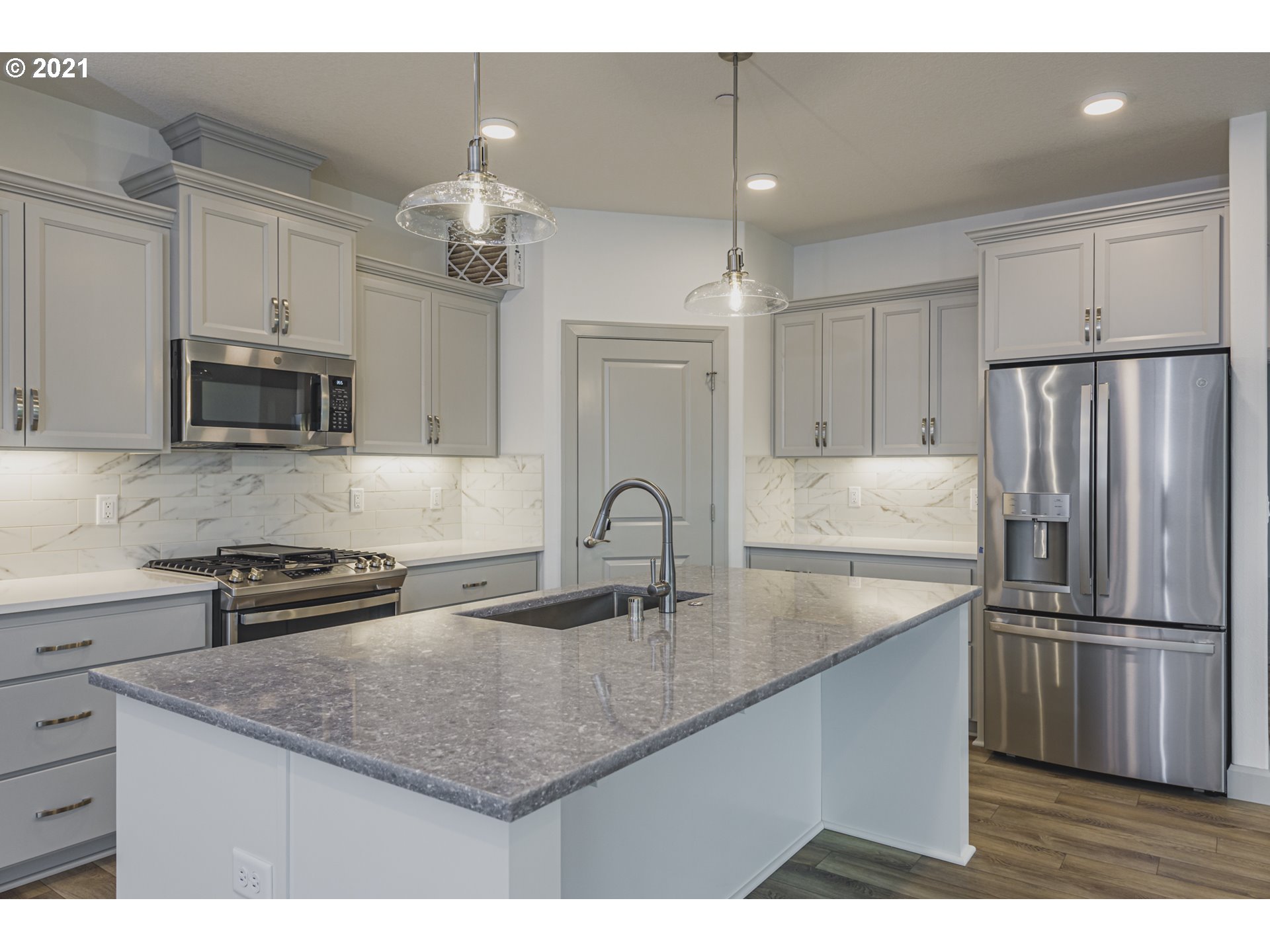 2325 South Royal Court Ridgefield, WA 98642 - Photo 4 of 30 a kitchen with kitchen island a counter space a sink appliances and cabinets
