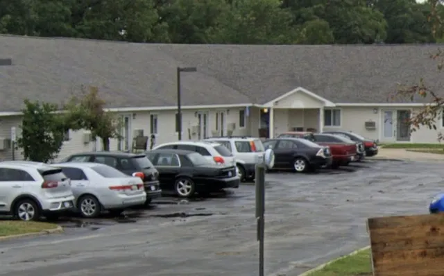 a couple of cars parked in front of a house