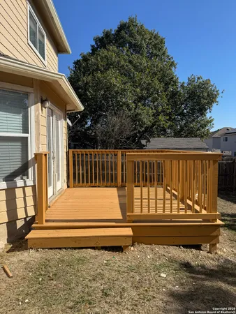 a view of backyard with wooden deck