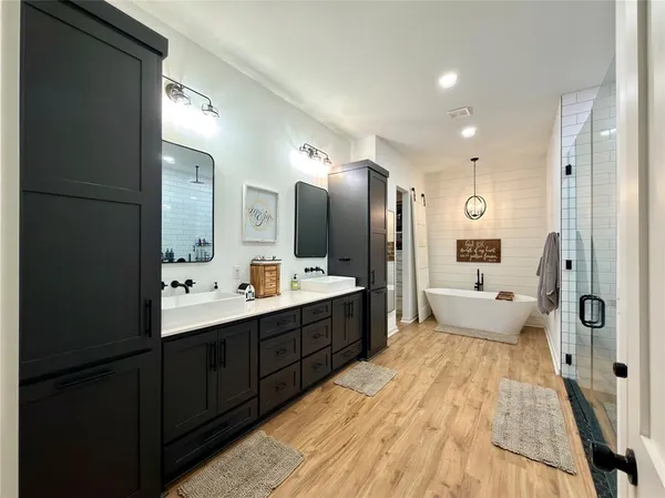a large bathroom with a double vanity sink mirror and shower