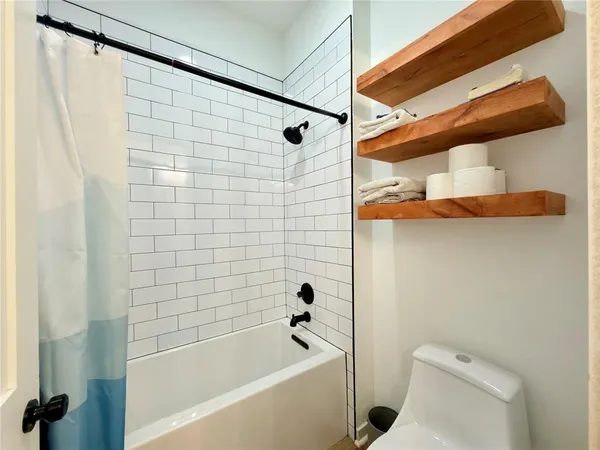 a bathroom with a bathtub and shower