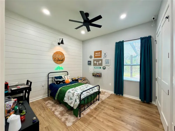 a bedroom with a bed and a chandelier