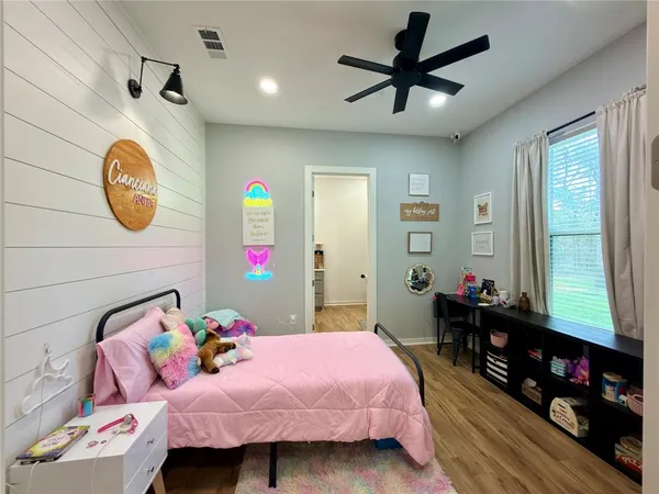 a bed room with a bed mirror and a window