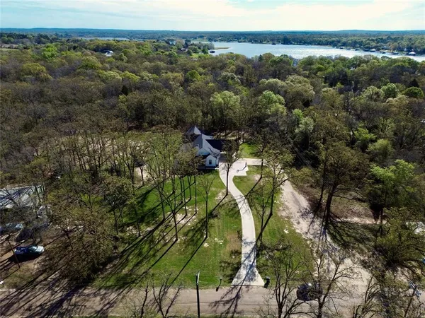 an aerial view of a house with a yard