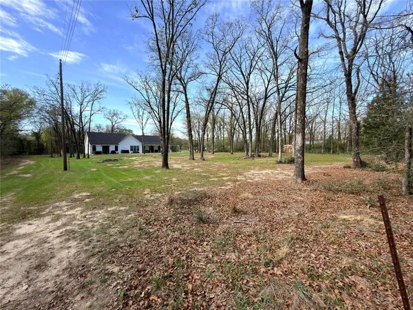 a front view of house with yard and trees