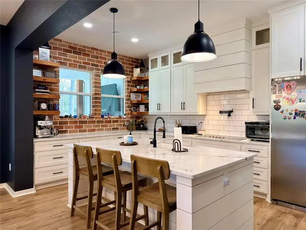 a kitchen with a sink cabinets and window