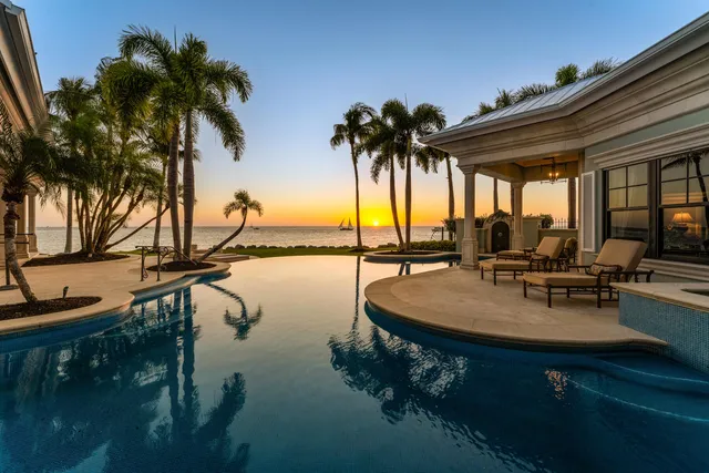 a view of swimming pool with a table and chairs