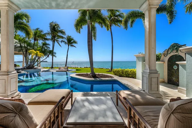 a view of house with swimming pool outdoor seating