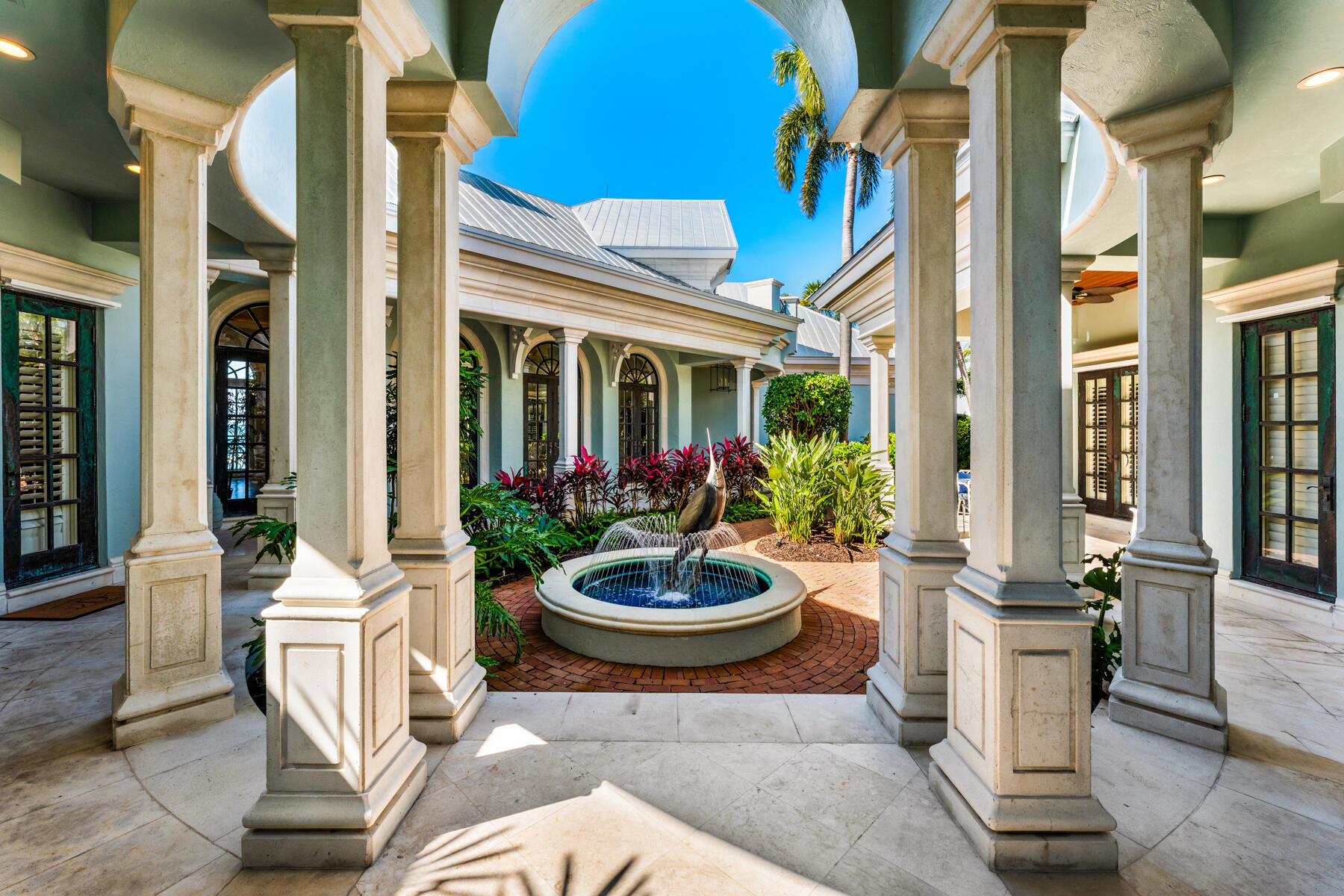 19 Sunset Key Drive Key West, FL 33040 - Photo 59 of 98 a view of a patio with a table and chairs and potted plants