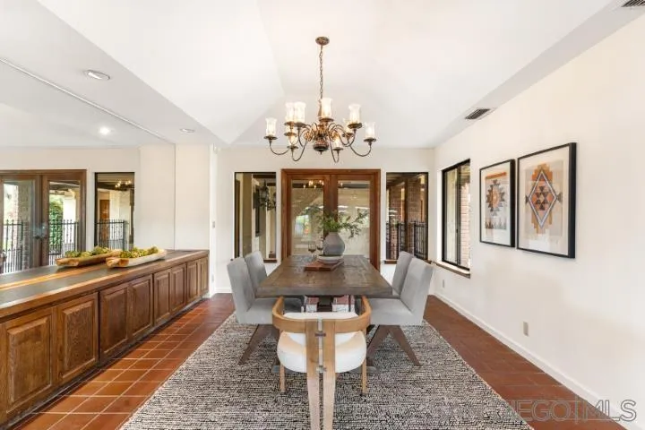 3253 Yucca Terrace Fallbrook, CA 92028 - Photo 19 of 62 a dining room with wooden floor a chandelier a wooden table and chairs
