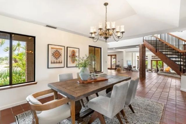 a kitchen with stainless steel appliances granite countertop a stove a sink dishwasher and a refrigerator with wooden cabinets