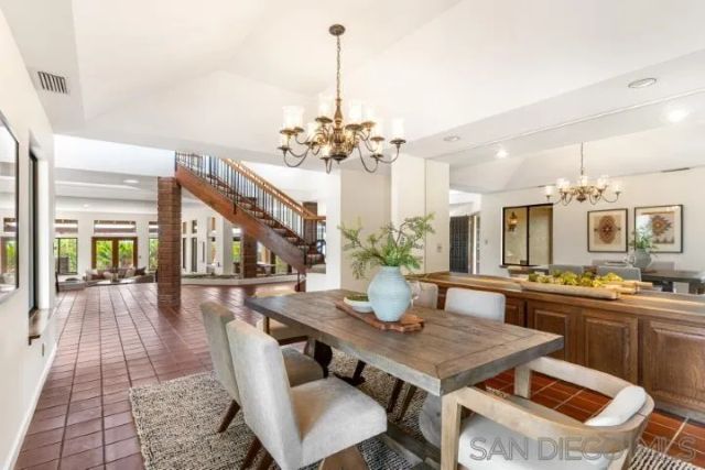 a view of a dining room with furniture large windows and wooden floor