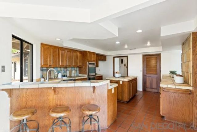 a kitchen with counter top space a sink and refrigerator