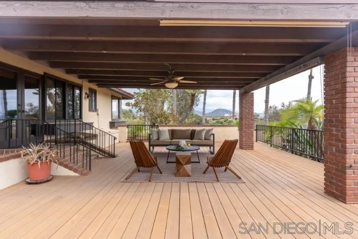 3253 Yucca Terrace Fallbrook, CA 92028 - Photo 44 of 62 a view of a patio with table and chairs and wooden floor
