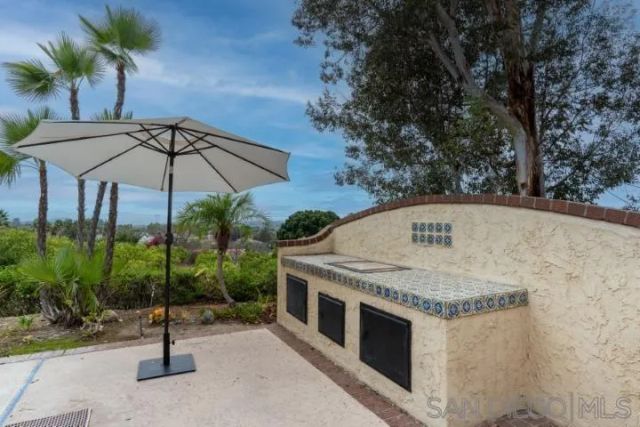 an aerial view of a house with a yard and trees