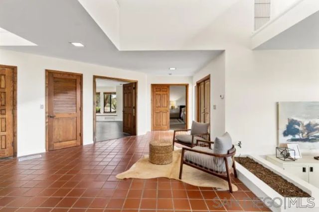 a living room with furniture stove and a large window