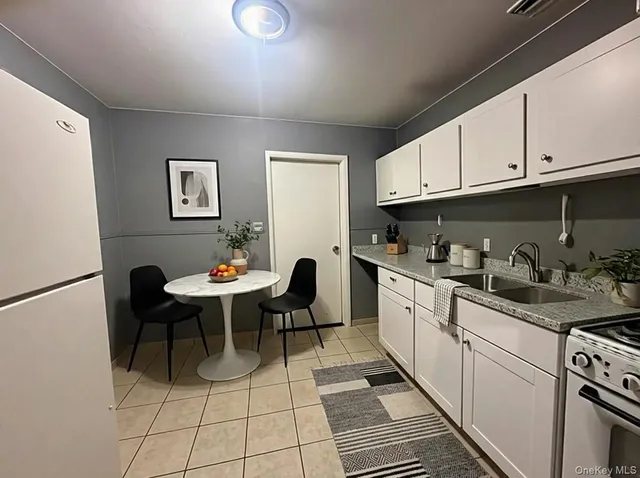a open kitchen with sink a dining table and chairs