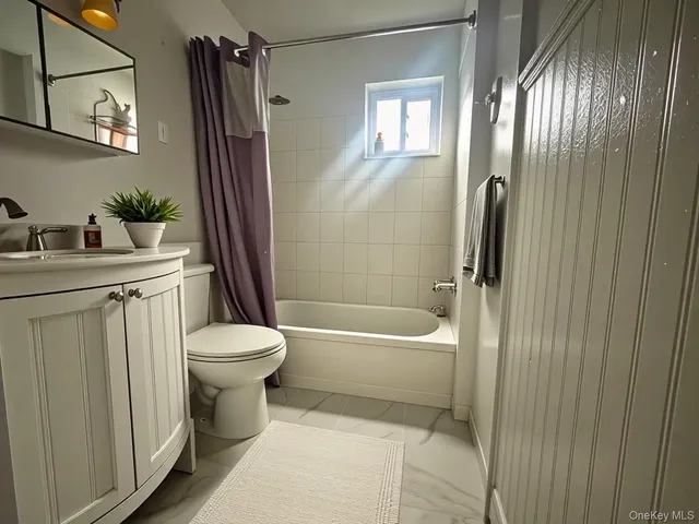 a bathroom with a toilet a sink and bathtub