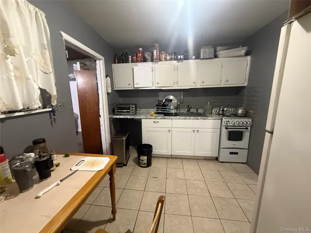 a kitchen with a sink a stove and cabinets