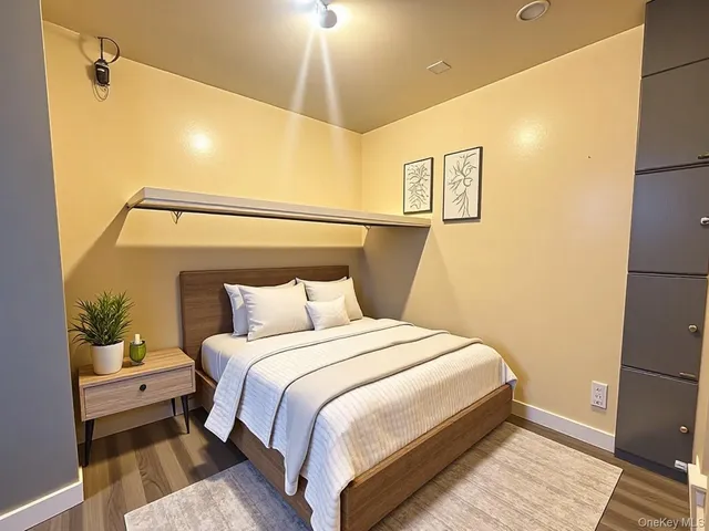 a bedroom with a bed and a potted plant