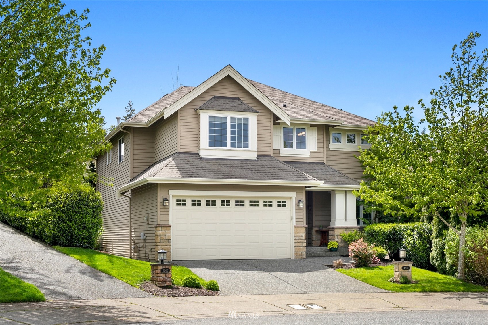 4202 221st Place Southeast Bothell, WA 98021 - Photo 1 of 28 a front view of a house with a yard and garage