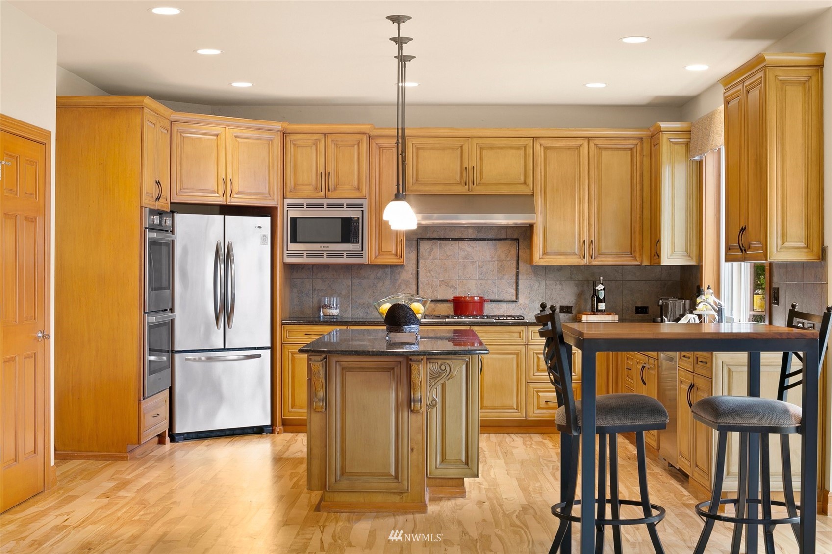 4202 221st Place Southeast Bothell, WA 98021 - Photo 9 of 28 a kitchen with stainless steel appliances granite countertop a refrigerator a stove a sink dishwasher and white cabinets with wooden floor