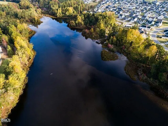 an aerial view of a house with a lake view
