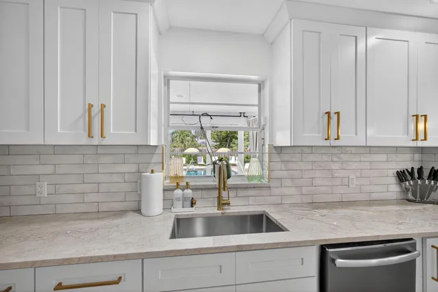a living room with kitchen island furniture and a floor to ceiling window