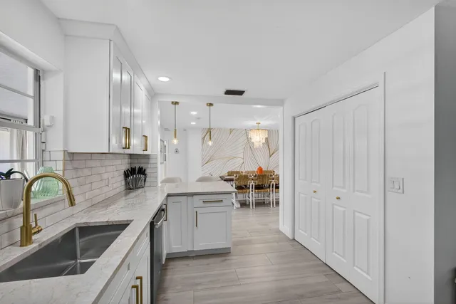 a view of a house with backyard sitting area and swimming pool