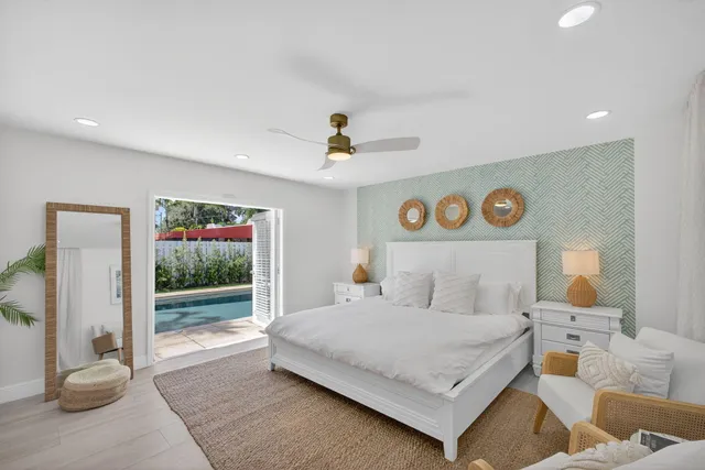 a bathroom with a granite countertop sink mirror and toilet